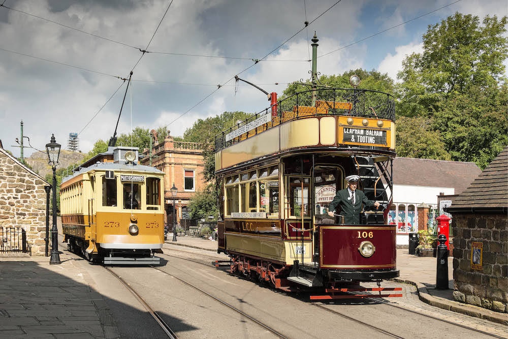 Family riding vintage trams at Crich Tramway Village in Derbyshire